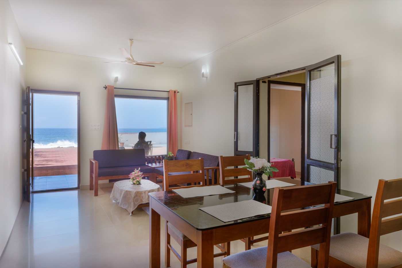 Ground-floor living room with doors open to the sea