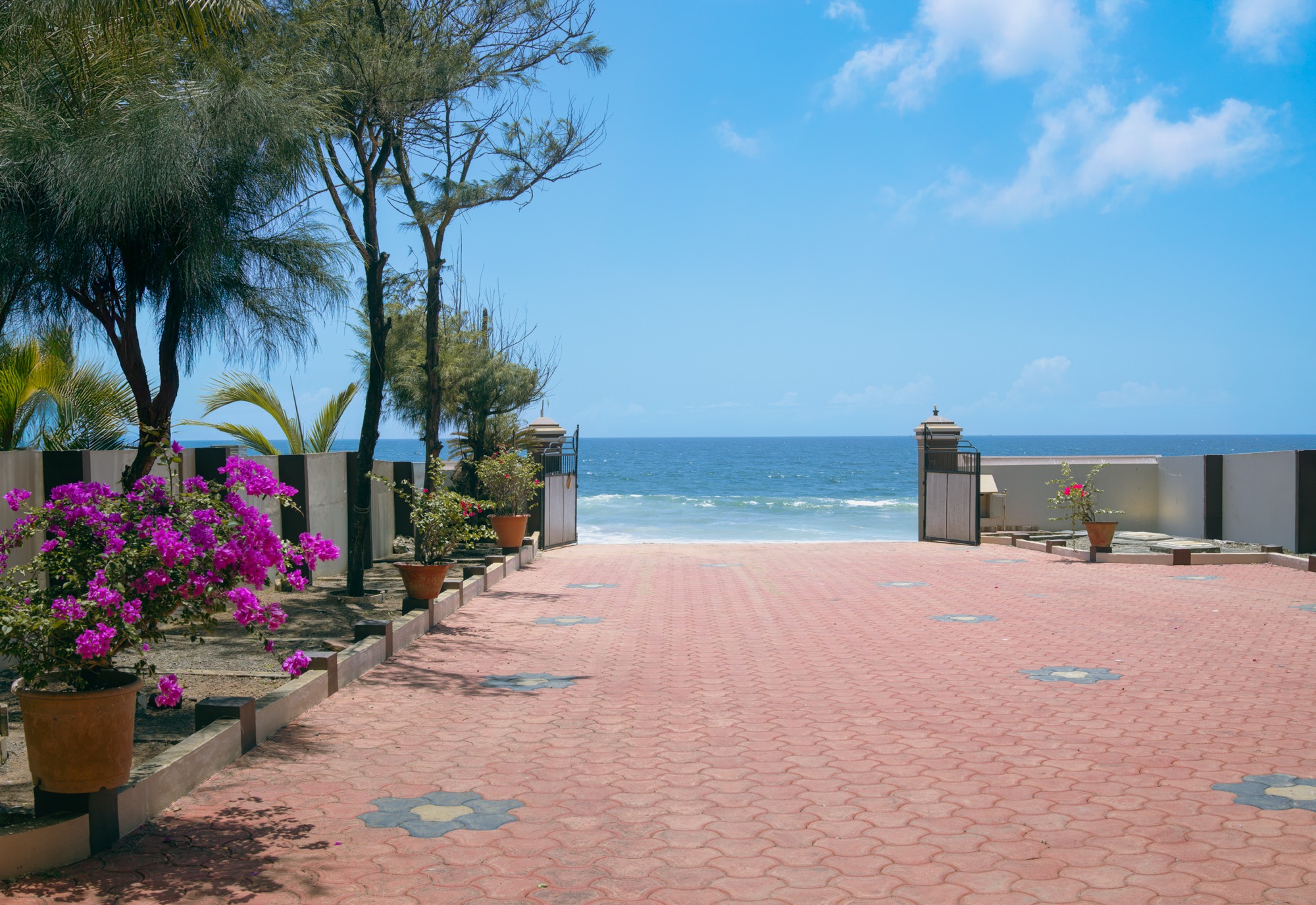 The courtyard gate of Endless Blue opening straight onto the beach and the Arabian Sea