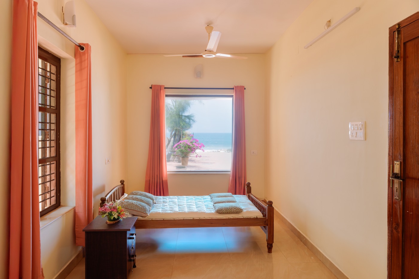 Ground-floor bedroom with a window looking out to the beach
