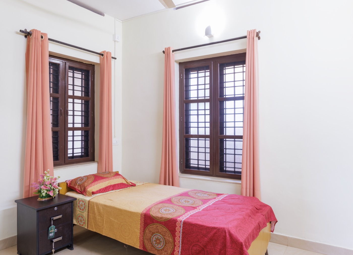 Ground-floor bedroom with two tall windows