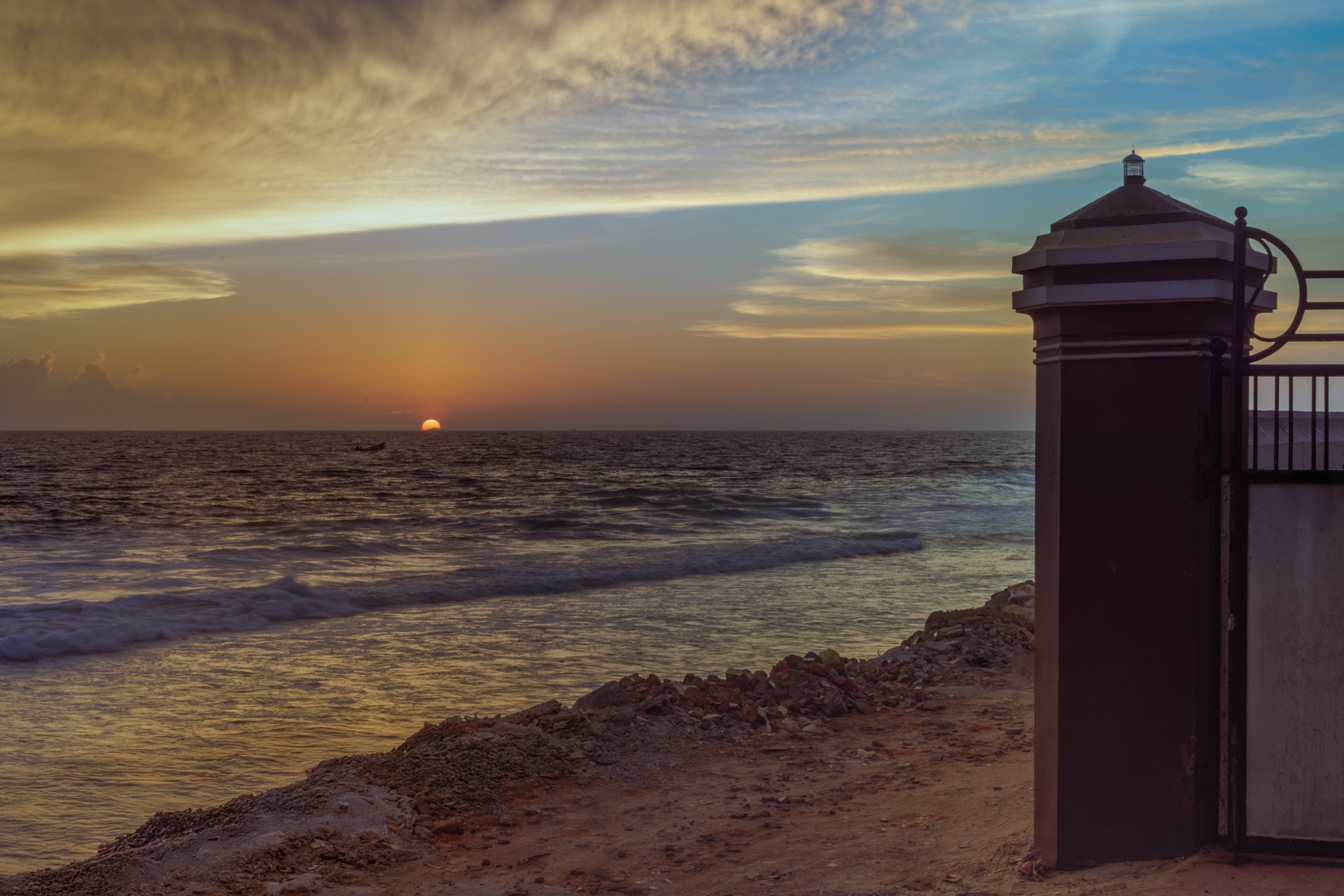 Sunset over the sea beside the Endless Blue gate